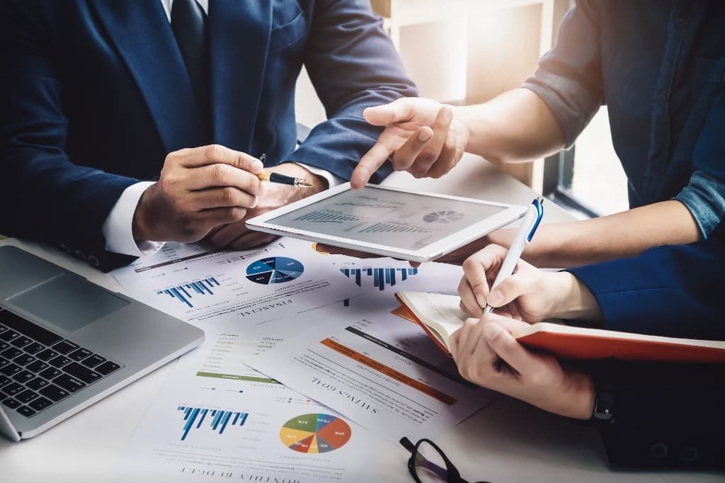 Advisors reviewing financial charts and documents together at a planning meeting
